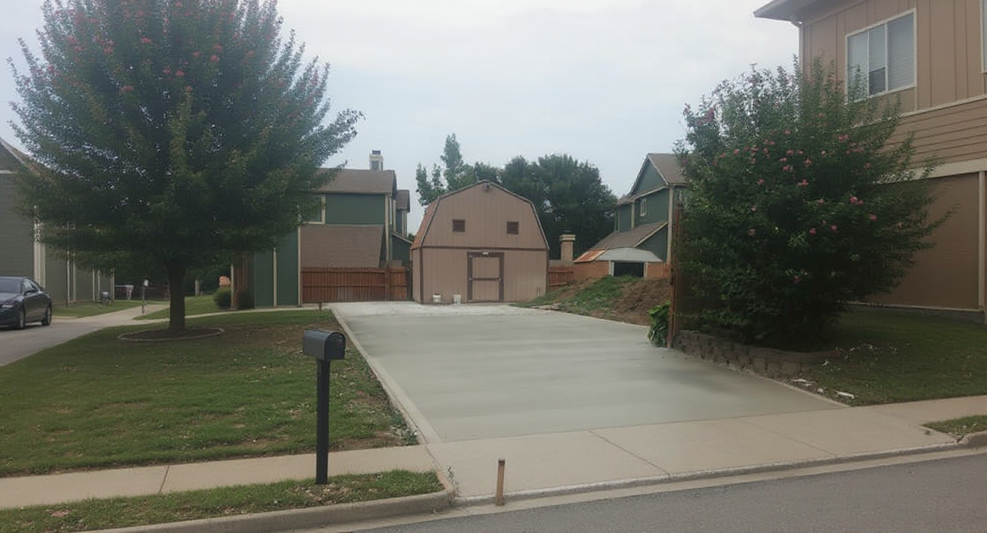 Street view of a long residential concrete driveway in Independence