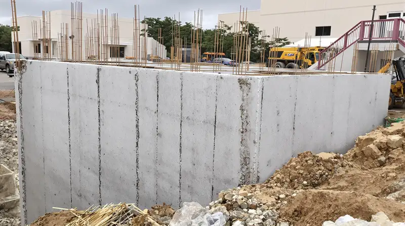 Freshly stripped concrete foundation walls with waterproofing at a Kansas City commercial construction site — Ford Concrete