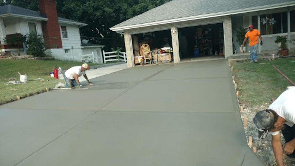 Concrete crew finishing driveway Kansas City — three workers | Ford Concrete