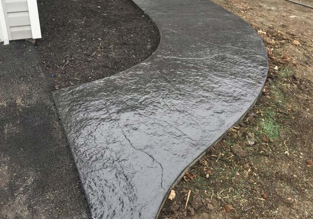 Stamped concrete walkway Kansas City — curved decorative path | Ford Concrete