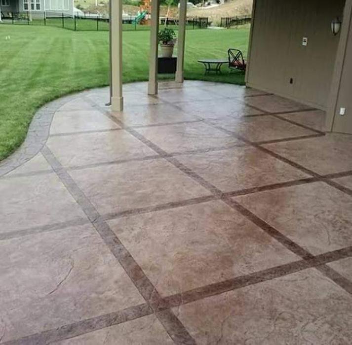 Sealed stamped concrete patio Kansas City — charcoal finish | Ford Concrete